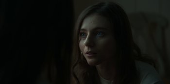 Movie still from “Lost Girls” (2020), directed by Liz Garbus – A beautiful young woman with blue eyes looking off into the distance; Close Up shot, Over the shoulder angle