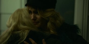 Movie still from “Lost Girls” (2020), directed by Liz Garbus – A woman with long blonde hair hugging another woman; Close Up shot, Over the shoulder angle