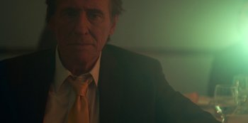 Movie still from “Lost Girls” (2020), directed by Liz Garbus – An older man wearing a suit and a yellow neck tie; Close Up shot, Low angle