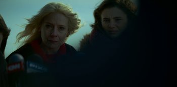 Movie still from “Lost Girls” (2020), directed by Liz Garbus – Two women standing next to each other on a beach; Close Up shot, Low angle