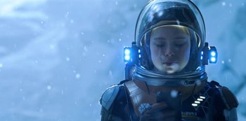 Movie still from “Lost in Space” (2018), created by Irwin Allen – A child in a space suit with a light on; Close Up shot, Low angle