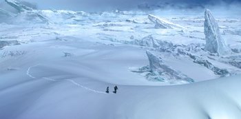 Movie still from “Lost in Space” (2018), created by Irwin Allen – Two skiers are walking up a snowy hill; Extreme Wide shot, High angle