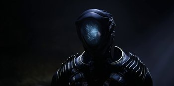 Movie still from “Lost in Space” (2018), created by Irwin Allen – The head of a robot with a glowing face; Close Up shot, Overhead angle