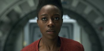 Movie still from “Lost in Space” (2018), created by Irwin Allen – A person wearing a red shirt; Close Up shot, Low angle