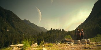 Movie still from “Lost in Space” (2018), created by Irwin Allen – An image of an outdoor scene with mountains and trees; Extreme Wide shot, Low angle