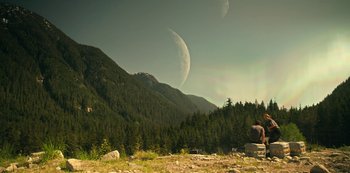 Movie still from “Lost in Space” (2018), created by Irwin Allen – A view of a mountain range with trees in the background; Extreme Wide shot, Low angle