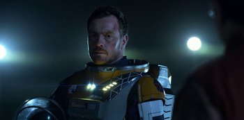 Movie still from “Lost in Space” (2018), created by Irwin Allen – A person wearing a suit; Close Up shot, Over the shoulder angle