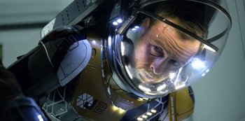 Movie still from “Lost in Space” (2018), created by Irwin Allen – A person wearing a space suit; Close Up shot, Overhead angle