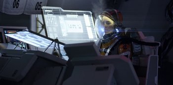 Movie still from “Lost in Space” (2018), created by Irwin Allen – A man in a space suit looking at a computer screen; Medium shot, Low angle