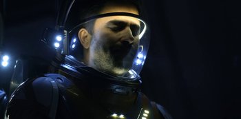 Movie still from “Lost in Space” (2018), created by Irwin Allen – A man wearing a space suit and a helmet; Close Up shot, Low angle