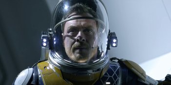 Movie still from “Lost in Space” (2018), created by Irwin Allen – A person wearing a space suit; Close Up shot, Low angle