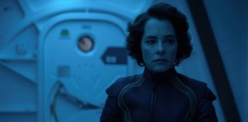 Movie still from “Lost in Space” (2018), created by Irwin Allen – A woman standing in front of an mri machine; Close Up shot, Over the shoulder angle