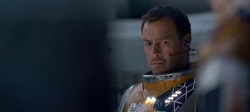 Movie still from “Lost in Space” (2018), created by Irwin Allen – A person wearing a helmet; Close Up shot, Over the shoulder angle