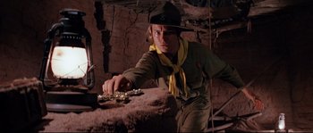 Movie still from “Indiana Jones and the Last Crusade” (1989), directed by Steven Spielberg – A man in a yellow hat and a yellow neck scarf; Medium shot, Low angle