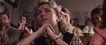 Movie still from “Indiana Jones and the Last Crusade” (1989), directed by Steven Spielberg – A girl with pigtails is holding her hands to her face; Close Up shot, Low angle