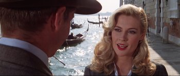 Movie still from “Indiana Jones and the Last Crusade” (1989), directed by Steven Spielberg – A man and a woman in front of a body of water; Close Up shot, Over the shoulder angle