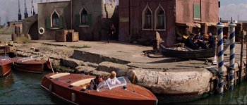 Movie still from “Indiana Jones and the Last Crusade” (1989), directed by Steven Spielberg – Two people are sitting in a boat on the water; Wide shot, High angle