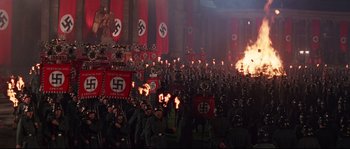 Movie still from “Indiana Jones and the Last Crusade” (1989), directed by Steven Spielberg – A large group of people in nazi garb in front of a building; Extreme Wide shot, High angle