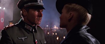 Movie still from “Indiana Jones and the Last Crusade” (1989), directed by Steven Spielberg – A man and a woman in military uniforms looking at each other; Close Up shot, Over the shoulder angle