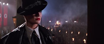 Movie still from “Indiana Jones and the Last Crusade” (1989), directed by Steven Spielberg – A woman wearing a black hat and a black coat; Close Up shot, Low angle