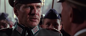 Movie still from “Indiana Jones and the Last Crusade” (1989), directed by Steven Spielberg – A person wearing a uniform; Close Up shot, Low angle