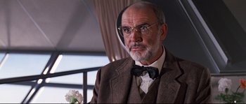 Movie still from “Indiana Jones and the Last Crusade” (1989), directed by Steven Spielberg – An older man wearing a suit and bow tie; Close Up shot, Low angle