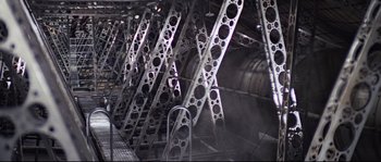 Movie still from “Indiana Jones and the Last Crusade” (1989), directed by Steven Spielberg – A large metal structure in the middle of a building; Extreme Wide shot, High angle