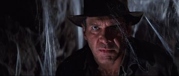 Movie still from “Indiana Jones and the Last Crusade” (1989), directed by Steven Spielberg – A person wearing a hat and looking at the camera; Close Up shot, Low angle