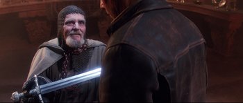 Movie still from “Indiana Jones and the Last Crusade” (1989), directed by Steven Spielberg – A man with a sword in his hand and another man in a leather jacket; Close Up shot, Over the shoulder angle