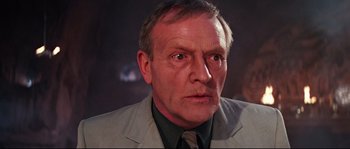 Movie still from “Indiana Jones and the Last Crusade” (1989), directed by Steven Spielberg – An older man wearing a suit and tie; Close Up shot, Low angle