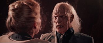 Movie still from “Indiana Jones and the Last Crusade” (1989), directed by Steven Spielberg – An old man and a young woman in a dark room; Close Up shot, Low angle