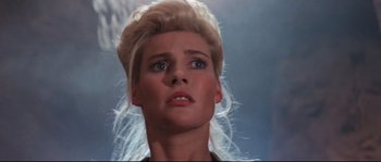 Movie still from “Indiana Jones and the Last Crusade” (1989), directed by Steven Spielberg – A person with a blonde wig; Close Up shot, Low angle