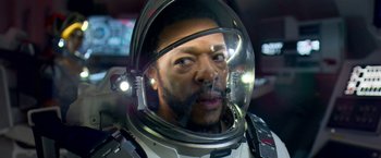 Movie still from “Lost in Space” (2018), created by Irwin Allen – A person wearing a space suit; Close Up shot, Over the shoulder angle