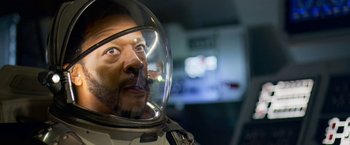 Movie still from “Lost in Space” (2018), created by Irwin Allen – A person wearing a space suit; Close Up shot, Low angle