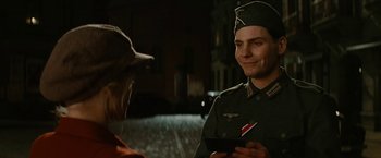 Movie still from “Inglourious Basterds” (2009), directed by Quentin Tarantino – A man in a military uniform is holding a tablet; Close Up shot, Over the shoulder angle