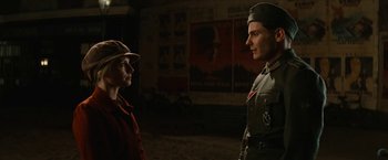 Movie still from “Inglourious Basterds” (2009), directed by Quentin Tarantino – A man and a woman are standing next to each other; Medium shot, Low angle