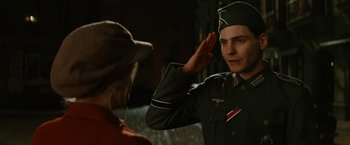 Movie still from “Inglourious Basterds” (2009), directed by Quentin Tarantino – A man saluting another man in a uniform; Close Up shot, Low angle