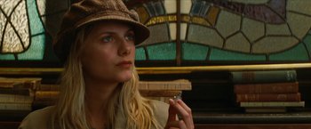 Movie still from “Inglourious Basterds” (2009), directed by Quentin Tarantino – A woman in a hat is smoking a cigarette; Close Up shot, Low angle