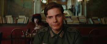 Movie still from “Inglourious Basterds” (2009), directed by Quentin Tarantino – A man in a uniform sitting in front of a woman; Close Up shot, Low angle