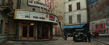 Movie still from “Inglourious Basterds” (2009), directed by Quentin Tarantino – A man standing in front of an old movie theater; Extreme Wide shot, High angle