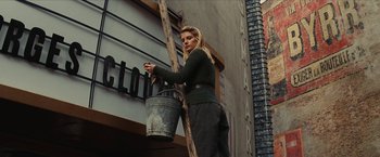Movie still from “Inglourious Basterds” (2009), directed by Quentin Tarantino – A woman holding a bucket on top of a wooden ladder; Medium shot, Low angle