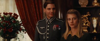 Movie still from “Inglourious Basterds” (2009), directed by Quentin Tarantino – A man and a woman wearing military uniforms; Close Up shot, Low angle