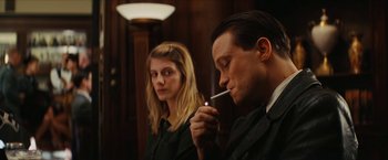 Movie still from “Inglourious Basterds” (2009), directed by Quentin Tarantino – A man and a woman are sitting next to each other; Close Up shot, Over the shoulder angle
