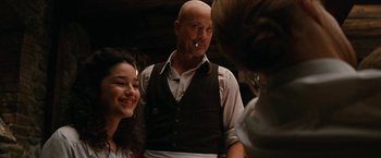 Movie still from “Inglourious Basterds” (2009), directed by Quentin Tarantino – A man smoking a cigarette next to a woman; Medium shot, Over the shoulder angle