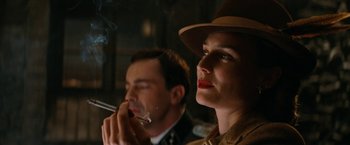 Movie still from “Inglourious Basterds” (2009), directed by Quentin Tarantino – A man and a woman are smoking a cigarette together; Close Up shot, Low angle