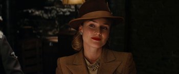 Movie still from “Inglourious Basterds” (2009), directed by Quentin Tarantino – A woman wearing a hat and a jacket; Close Up shot, Low angle