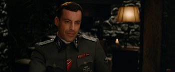 Movie still from “Inglourious Basterds” (2009), directed by Quentin Tarantino – A person wearing a uniform; Close Up shot, Over the shoulder angle