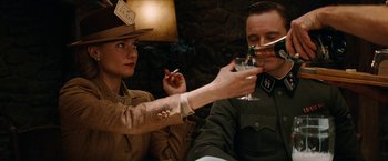 Movie still from “Inglourious Basterds” (2009), directed by Quentin Tarantino – A man and a woman are drinking wine; Medium shot, Low angle