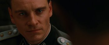 Movie still from “Inglourious Basterds” (2009), directed by Quentin Tarantino – A person wearing a uniform; Close Up shot, Over the shoulder angle