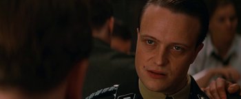 Movie still from “Inglourious Basterds” (2009), directed by Quentin Tarantino – A person wearing a military uniform; Close Up shot, Over the shoulder angle